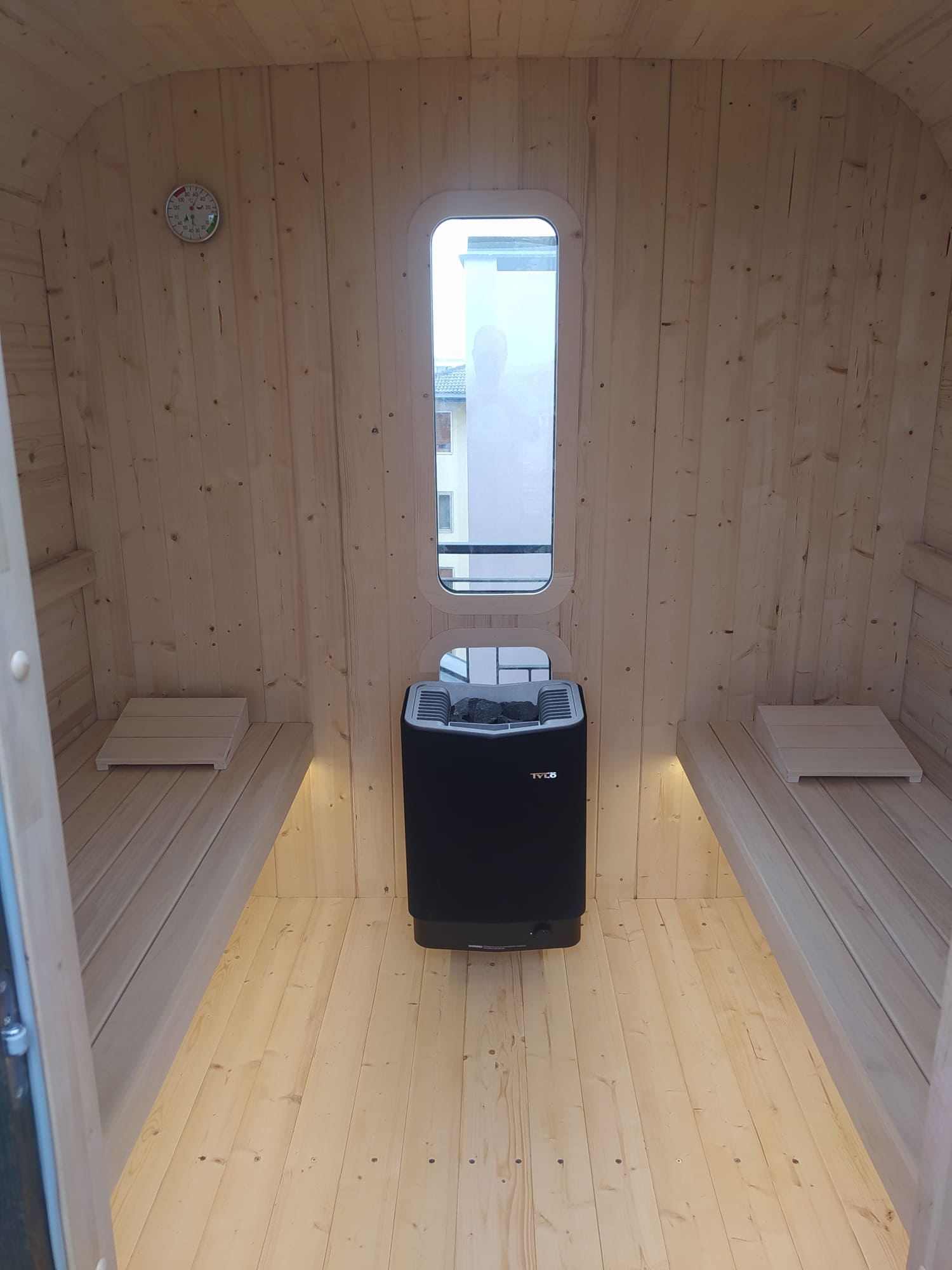 panche interne della sauna da esterno cube flat con stufa elettrica Tylo e illuminazione sotto le panche